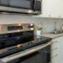 Taunton Terrace in Oshawa, ON kitchen with full range stove and over-the-range microwave Taunton Terrace in Oshawa, ON kitchen with full range stove and over-the-range microwave
