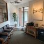 Reception Area of Dunwin Dental with Chairs, a plant and coffee machine on a table Reception Area of Dunwin Dental with Chairs, a plant and coffee machine on a table