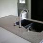 Solid Surface top with black granite undermount sink Solid Surface top with black granite undermount sink