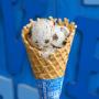 A freshly baked waffle cone in a Ben & Jerry's ice cream shop. A freshly baked waffle cone in a Ben & Jerry's ice cream shop.