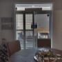 Composite Shutters with Divider Rail and Bifold Panels on a Patio Door in a Newmarket Home Composite Shutters with Divider Rail and Bifold Panels on a Patio Door in a Newmarket Home
