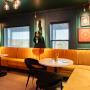 Black Roller Shades in a colourful speakeasy Black Roller Shades in a colourful speakeasy