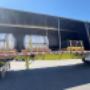 Flatbed loaded with packaged freight – Safe and efficient delivery of commercial goods. Flatbed loaded with packaged freight – Safe and efficient delivery of commercial goods.
