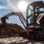 Bobcat Mini E-35 ExcavatorDigging Large Hill of Dirt Bobcat Mini E-35 ExcavatorDigging Large Hill of Dirt