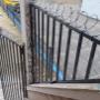 Custom staircase guard and gate with hand-rolled barbed wire Custom staircase guard and gate with hand-rolled barbed wire