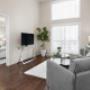 Living room with large windows and luxury vinyl plank flooring at Elizabeth Gardens in Edmonton, AB Living room with large windows and luxury vinyl plank flooring at Elizabeth Gardens in Edmonton, AB