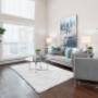 Living room with large windows and luxury vinyl plank flooring at Elizabeth Gardens in Edmonton, AB Living room with large windows and luxury vinyl plank flooring at Elizabeth Gardens in Edmonton, AB