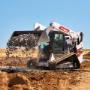 Bobcat T86 dumping and spreading rock with bucket Bobcat T86 dumping and spreading rock with bucket