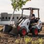 A Bobcat L23 small articulated loader with bucket attachment A Bobcat L23 small articulated loader with bucket attachment
