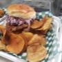 Crispy Cajun Chicken Thigh burger topped with house made apple dill slaw served with house made BBQ kettle chips Crispy Cajun Chicken Thigh burger topped with house made apple dill slaw served with house made BBQ kettle chips