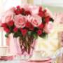 A stunning bouquet of pink roses and red spray roses elegantly arranged in a pink glass vase. Perfect for gifting on Valentine's Day, anniversaries, or as a thoughtful gesture to brighten someone’s day. A stunning bouquet of pink roses and red spray roses elegantly arranged in a pink glass vase. Perfect for gifting on Valentine's Day, anniversaries, or as a thoughtful gesture to brighten someone’s day.