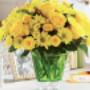 A cheerful arrangement of bright yellow roses and daisies displayed in a vibrant green glass vase, creating a sunny and uplifting centerpiece. This floral design is ideal for spring celebrations, birthdays, or sending a warm 'get well soon' message. A cheerful arrangement of bright yellow roses and daisies displayed in a vibrant green glass vase, creating a sunny and uplifting centerpiece. This floral design is ideal for spring celebrations, birthdays, or sending a warm 'get well soon' message.