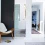 Matte black doors and gold hardware add a modern touch to the crisp all white walls, trim and flooring Matte black doors and gold hardware add a modern touch to the crisp all white walls, trim and flooring