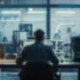 A professional image of an IT technician working with a computer and securing network connections in a modern office environment. A professional image of an IT technician working with a computer and securing network connections in a modern office environment.