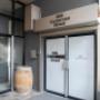 Lobby entrance with glass double doors, interior lights visible through tall windows, and building number signage displayed prominently. Lobby entrance with glass double doors, interior lights visible through tall windows, and building number signage displayed prominently.