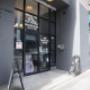 Street-facing entrance at 889 Carnarvon Street featuring glass doors with signage for office rentals and a tattoo studio. Visible A-frame signs promote on-site businesses. Street-facing entrance at 889 Carnarvon Street featuring glass doors with signage for office rentals and a tattoo studio. Visible A-frame signs promote on-site businesses.