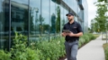 Seaside Pest Control Technician Conducting Inspection Outside Commercial Office Building in Vancouver